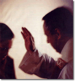Priest Absolving Someone in the Confessional